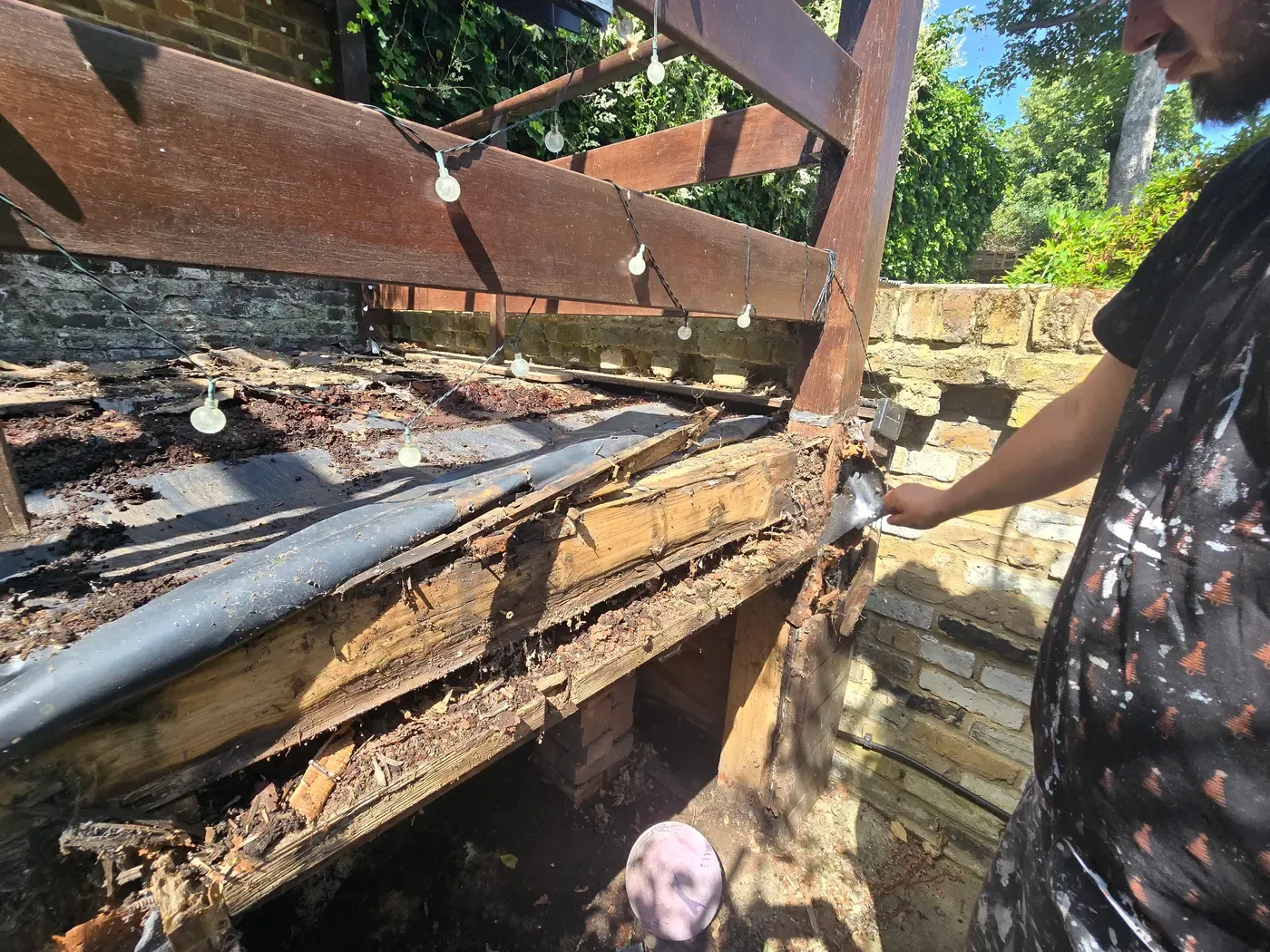 Decking repair — rotten joists exposed in W8